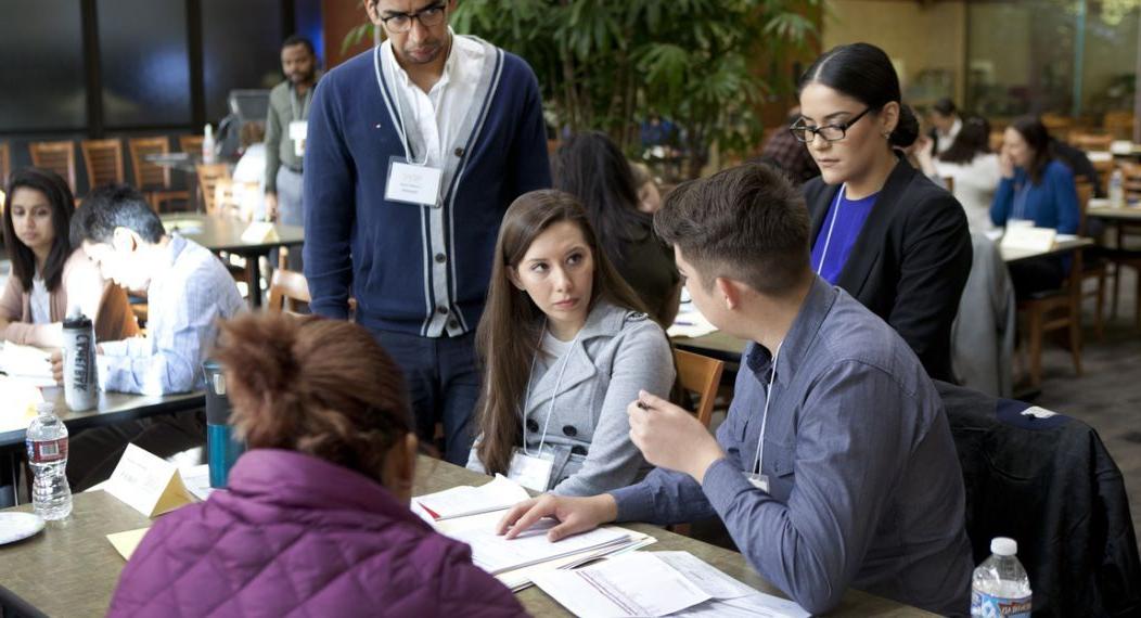 students helping at the mcgeorge immigration fair